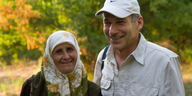 William Ury (right) poses with a woman (left) in front of trees in northern Jordan